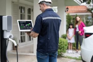 qualified-technician-working-with-laptop-home-ev-station_synchronos